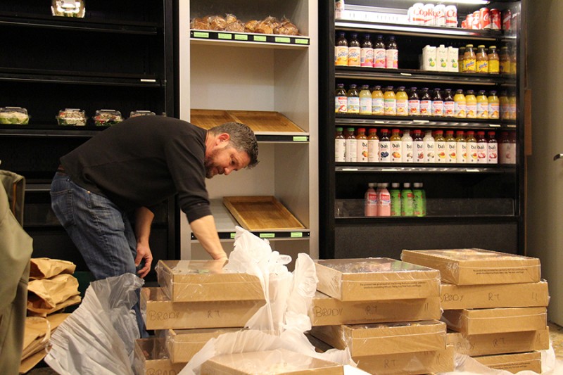 A man unpacks cardboard boxes