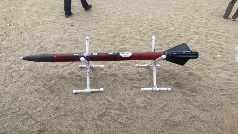 A small rocket surrounded by sand