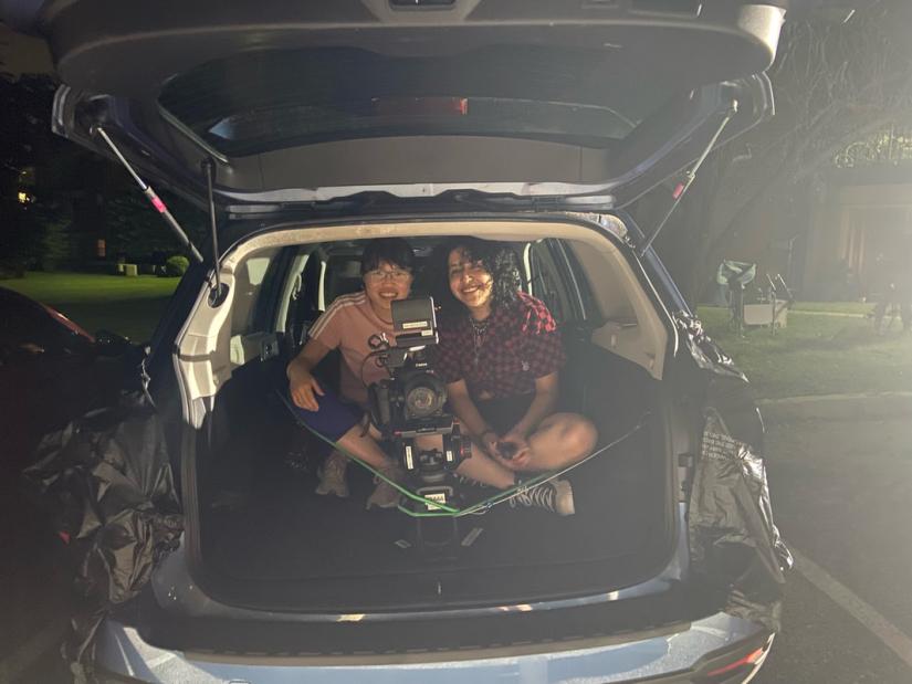 Student filmmakers moments before shooting a scene for *Sundown* (2023) from a moving car