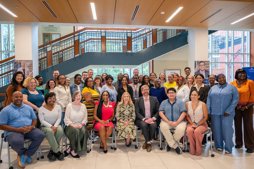 Attendees at the mentoring program launch gather four a group photo.