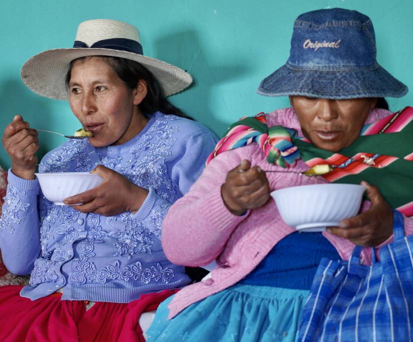 Women taste soup prepared using the thermal cooker