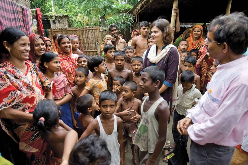 A group of people talk with representatives from the Johns Hopkins India Institute