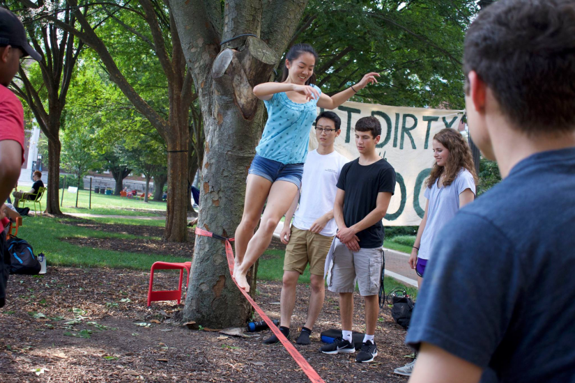 Students from the Johns Hopkins Outdoor Club slackline on campus.