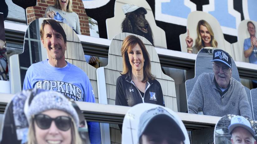 Cardboard cutouts of fans in stands