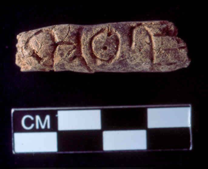 Alphabetic text inscribed on a beadlike form