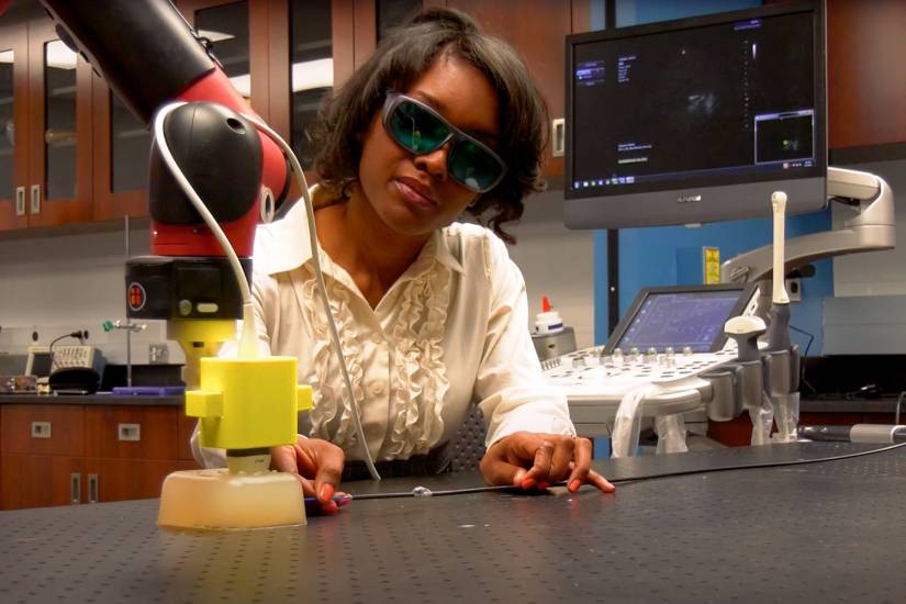 Muyinatu Bell works with a device in her laboratory