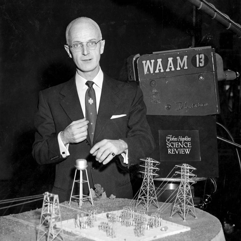 Poole stands over an architectural model