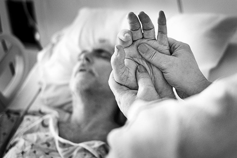 A hospital patient has a hand massage