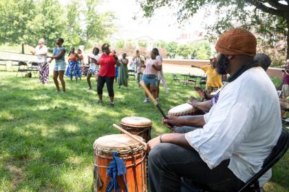 People dance and play drums