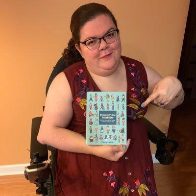 Emily Ladau holds her book, 'Demystifying Disability'