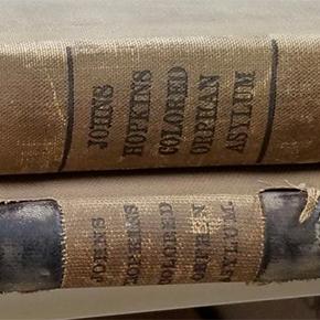 Two worn book spine, both reading 