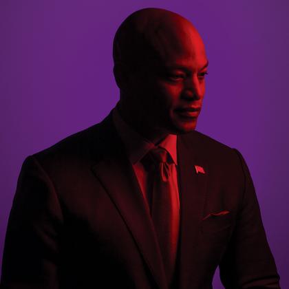 A color gel treated photo of Wes Moore against a purple background