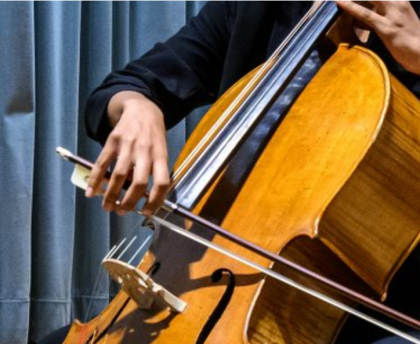 Close-up photo of a person's arms playing an upright bass
