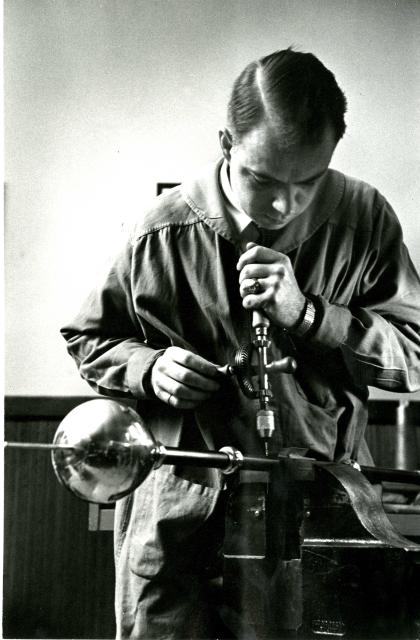 Candid photograph of Hopkins at approximately 39 years old, working on the Johns Hopkins University Mace