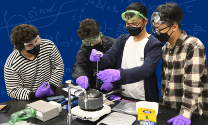 Photograph of a group of students perform a lab experiment