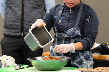 Chef Kat prepares ingredients for the dish.