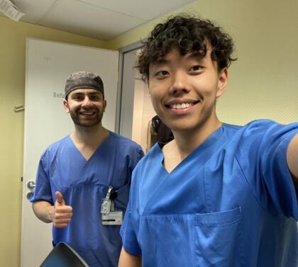 A selfie of Yazan Moshen and Toby Mao dressed in hospital scrubs. 