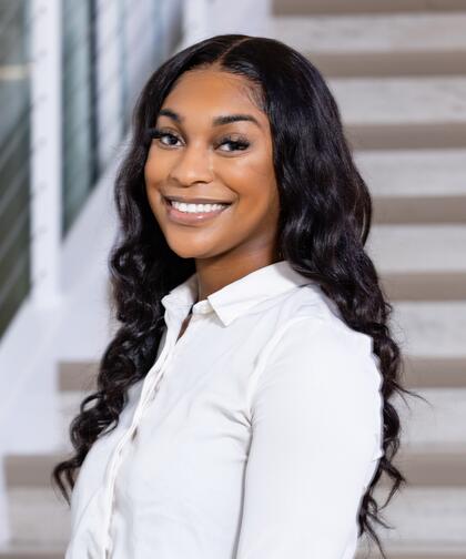 A professional headshot of Faith Metlock