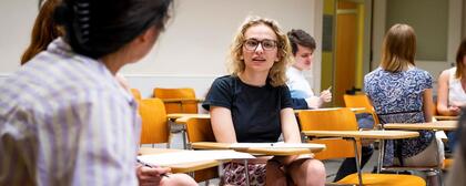 Madison Epner, a female undergraduate student, talks to a fellow student in her WBS class
