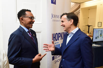 Representative Kweisi Mfume chats with JHU President Ron Daniels.