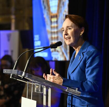 Mary Woolley speaks at a podium