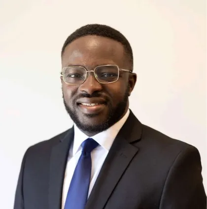 A professional headshot of Festus Babarinde