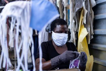 A woman works in a face mask manufacturing shop in a factory in Harare, Zimbabwe