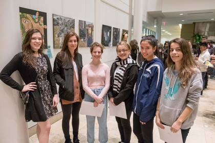 Six student artists pose for a photo