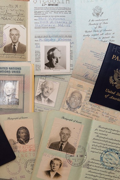Passport photos laid out in a messy collage