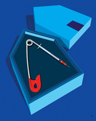 Illustration shows a safety pin with a disposable needle on the end, encased in a house-shaped box
