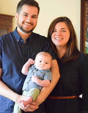 Couple poses with their baby son