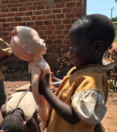 A child in Uganda looks at the medical manikin