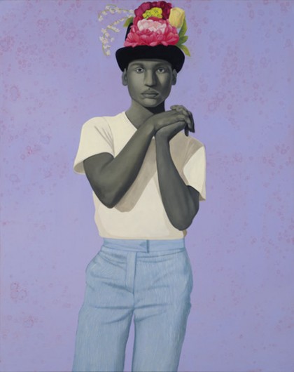 A man stares seriously out from this portrait; he clasps his hands with interlaced fingers and bends his left hand backwards; his skin is in a gray tone; he wears a white tee shirt and a color hat topped with flowers