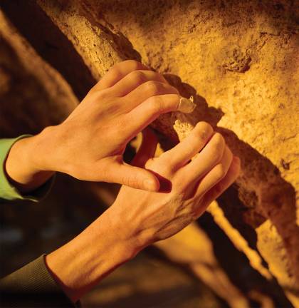closeup of Jessamy Taylor's hands as she rock climbs