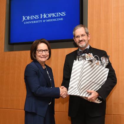 Janice Clements, vice dean for faculty, presents award to James Ficke, director of Orthopaedic Surgery