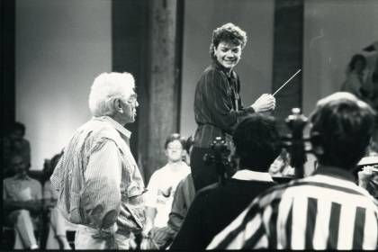 Black and white archival photograph of Marin Alsop leading an orchestra