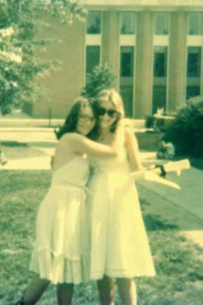 In a faded family snapshot taken in 1976 in front of Garland Hall on Johns Hopkins' Homewood campus, Cindy congratulates big sister Joan, who has just received her master's degree.