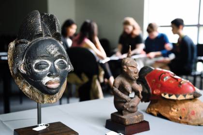 A pair of African masks and a wooden figurine