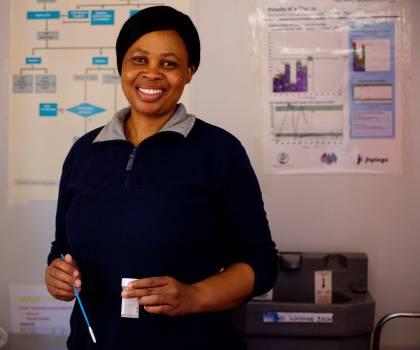 Nurse Motlalepula Masiele holds a cervical cancer screening tool
