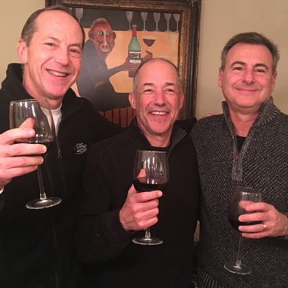 Three men cheers at New Year's Eve