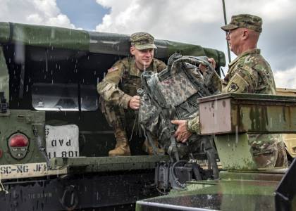 National Guard soldiers load a Humvee