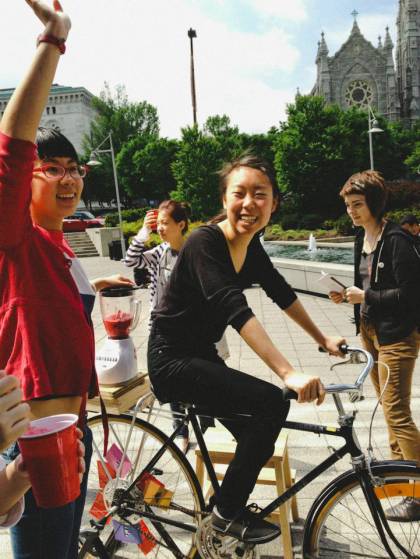 Woman on a bike churning a blender