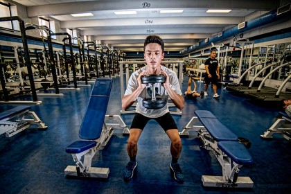 Alex Doran doing squats in the varsity weight room.
