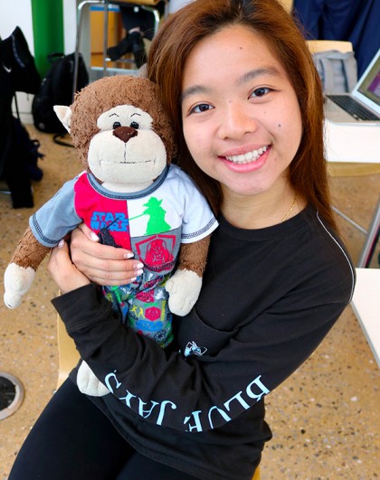 Tiffany Chan poses with stuffed monkey