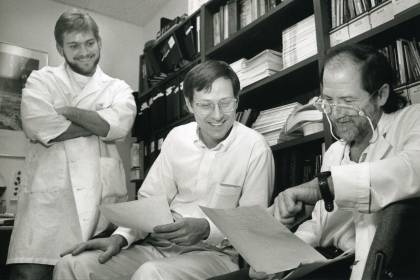 Photograph of Bert Vogelstein and Ken Kinzler looking over paperwork