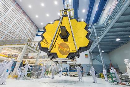 Technicians use a crane to lift the James Webb Space Telescope inside a clean room at NASA’s Goddard Space Flight Center in Greenbelt, Maryland