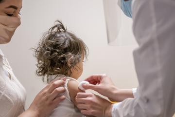A toddler receives a vaccine