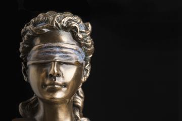 Photo of a statue of the Goddess of Justice, who is blindfolded