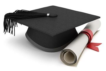 Black mortarboard next to a rolled-up degree tied in a red ribbon