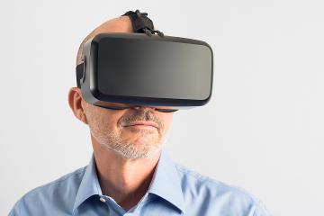 Middle-aged man wearing a virtual reality headset